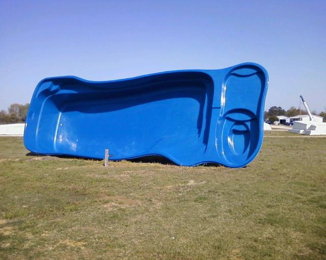 Copano Pools and Spas professional team installing a fiberglass shell